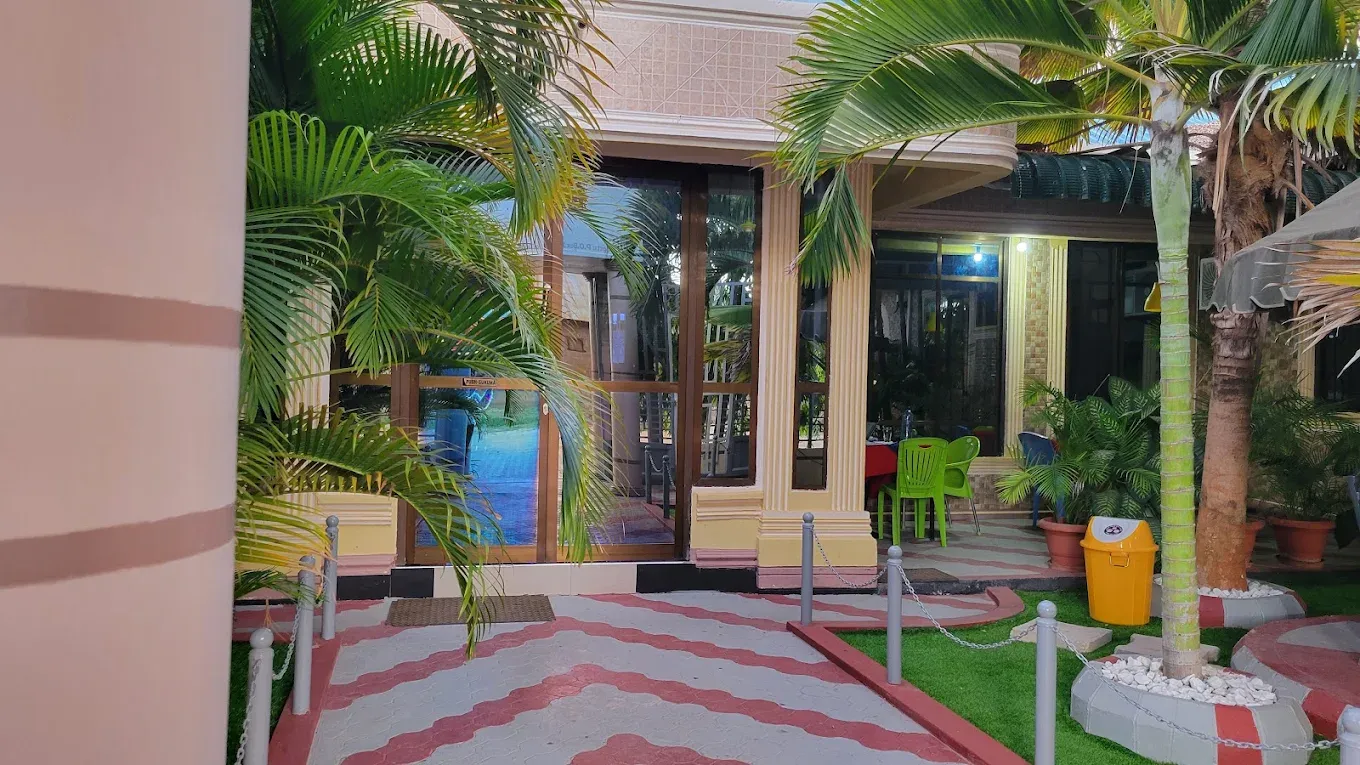 The garden walkway between palms leading to reception at dusk