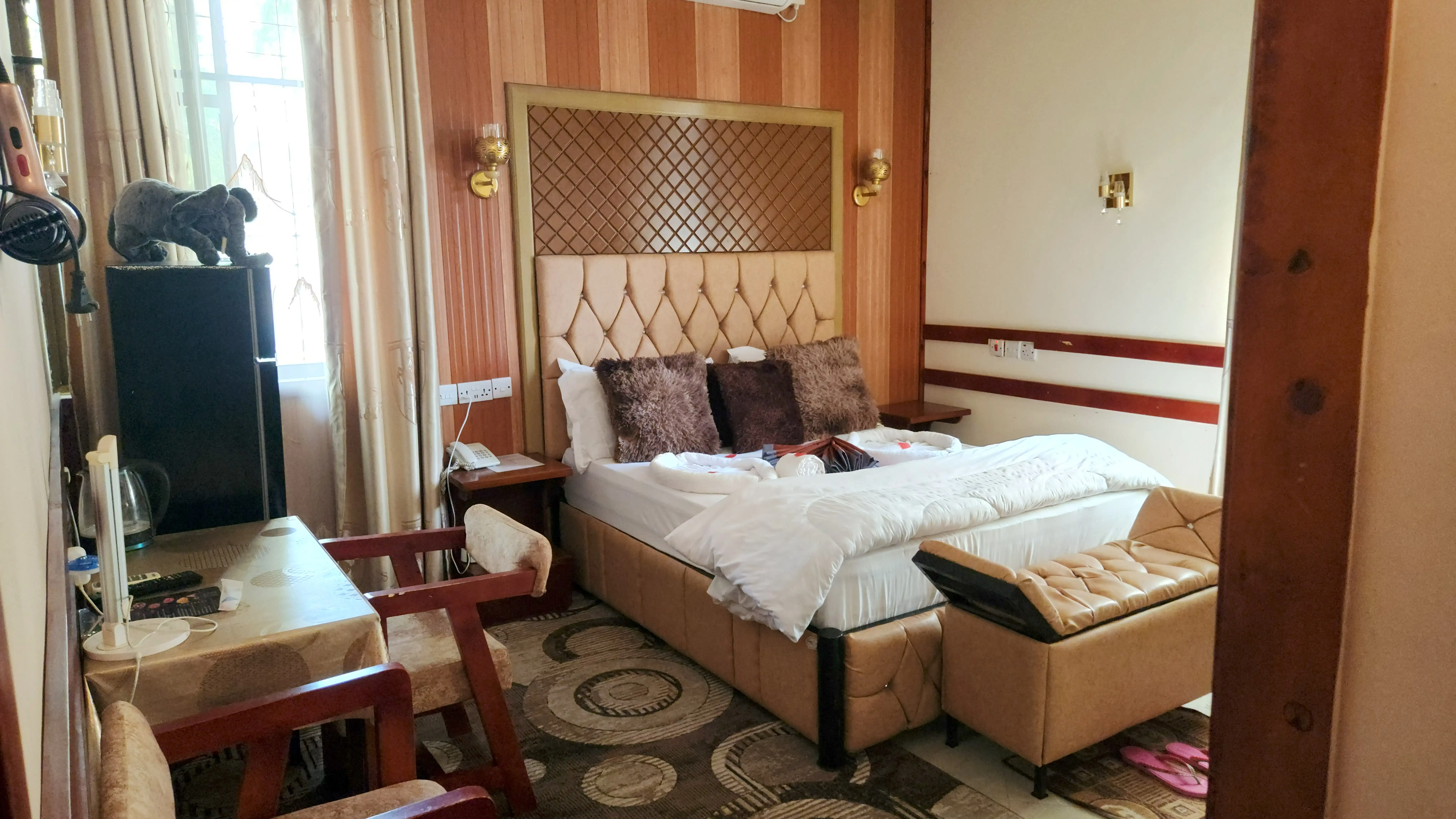 Quilted headboard and brass lamps in the Superior King